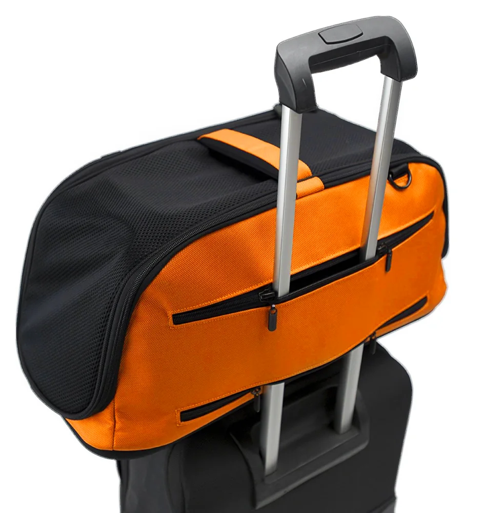 Orange Dream Sleepypod Air pet carrier attached to a rolling suitcase.